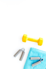Equipment for fitness. Dumbbells and expander on white background top view copyspace
