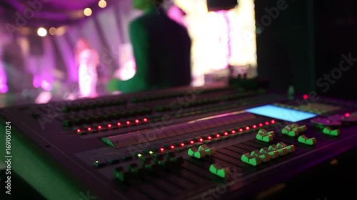 Soundman Near The Professional Audio Console In A Concert
