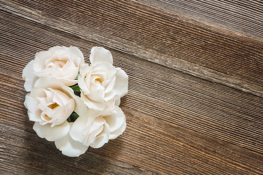White Roses on Rustic Wooden Table