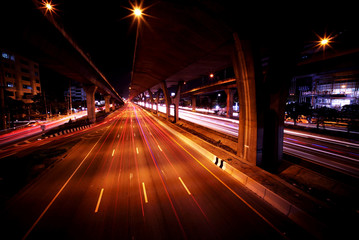 Fototapeta na wymiar Light trails of fast moving Cars in the City and on the Expressway at midnight