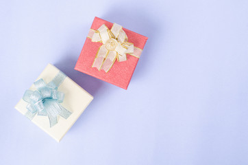 Gift box on light blue background for giving in holidays