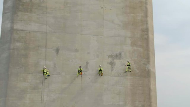 Safety Inspectors Working at Height on a Concrete Bridge Checking for Cracks, Wear and Tear