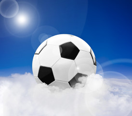 Soccer ball over clouds against blue sky