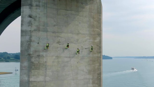 Safety Inspectors Working at Height on a Concrete Bridge Checking for Cracks, Wear and Tear
