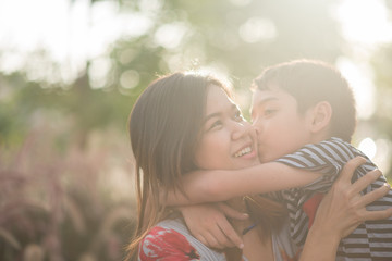 Single mom walking with son together with happy face