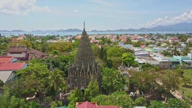 City by Sea against Hills and Coral Temple on Foreground