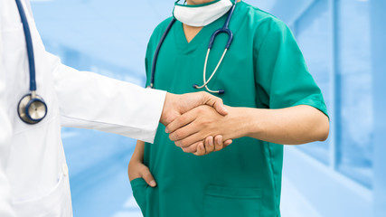 Doctors shaking hands. Medical people teamwork.