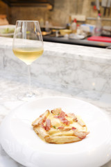 Pasta with bacon in cream sauce serving with white wine