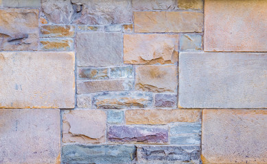 background texture of a wall of multi-colored stone
