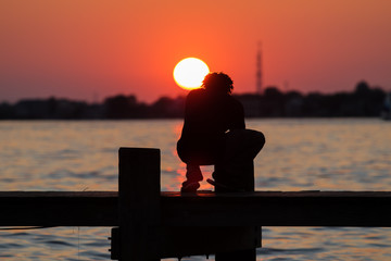 Man crabbing fishing during sunset on the boardwalk