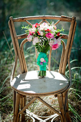 A bridal bouquet with roses, eustoma, berries A bridal bouquet on an ancient chair. Floristic...