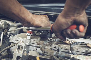 Hands of mechanic working in auto repair shop