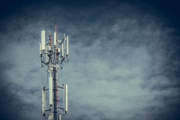 Mobile phone communication antenna tower with the blue sky and clouds