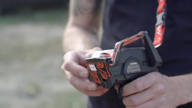 Player hand hold remote control play pad 4k slow-motion video. Gamer controls radio controlled car toy with distance device