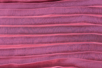 Fototapeta na wymiar Red fabric folds over white wood background texture