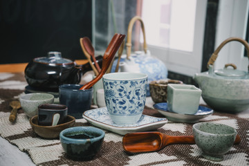 Tea cups with teapot on old wooden table