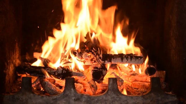 Hot fireplace full of burning wood and fire