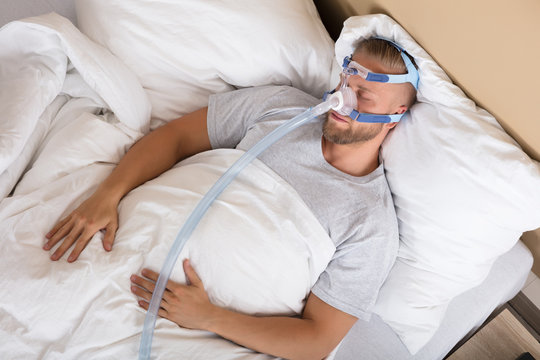 Man With Sleeping Apnea And CPAP Machine