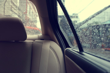 back seat inside vehicle car with rain drop on window