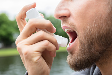 Man Using Asthma Inhaler