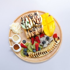 Toast with fruit served with honey and condensed milk