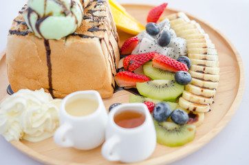 Toast with fruit served with honey and condensed milk