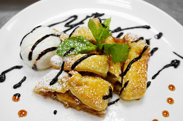 apple strudel with mint and ball of vanilla ice cream