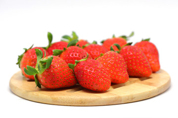 red strawberry on wooden plate