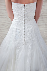 Fototapeta na wymiar White wedding dress, dressed for the bride, a fragment.