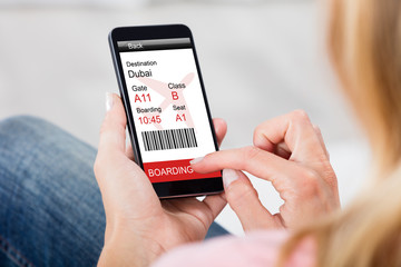 Woman Reading News On Mobile Phone