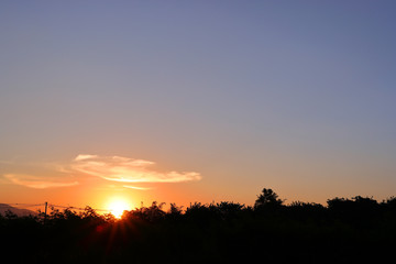 Fototapeta na wymiar orange sun light on beautiful sunset clear blue sky background
