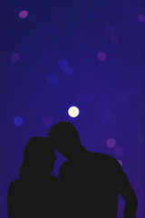 Silhouettes of a young couple under the de-focused starry sky. My astronomy work.