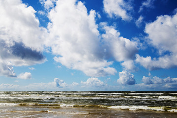 beautiful sky with puffy clouds above sea