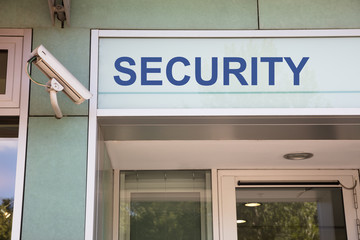 Security camera and sign at entrance