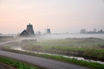 the early morning in the town of Kinderdijk in Netherland, with a heavy fog and village view
