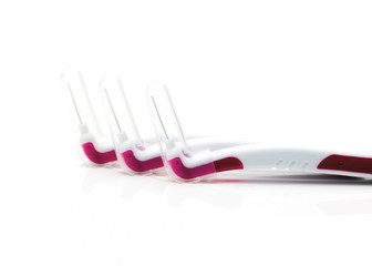Three interdental brush with cover isolated on white background with copy space, just add your own text