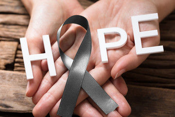Hand Showing Ribbon With Hope Text