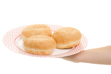 Female hand buns for hamburgers on a plate