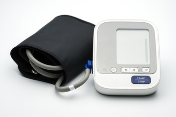 Automatic blood pressure monitor with wide range cuff on white background with copy space