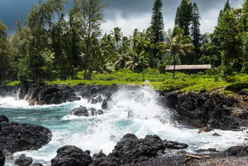Surf hitting volcanic rocks at the coastline of Maui, Hawaii