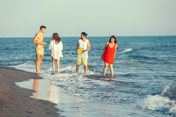 Group of friends together on the beach having fun.