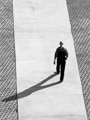 Man is walking down the pathway at sunny morning in Belgrade, Serbia