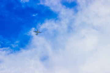 Airplane in the cloudy sky. Travel concept