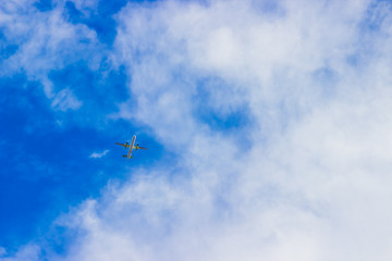 Airplane in the cloudy sky. Travel concept