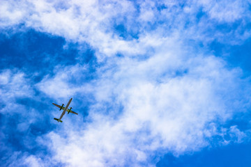 Fototapeta na wymiar Airplane in the cloudy sky. Travel concept