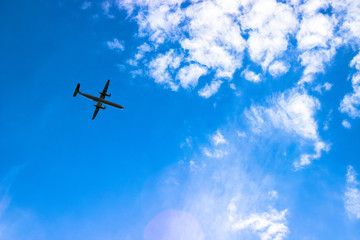 Airplane in the cloudy sky. Travel concept