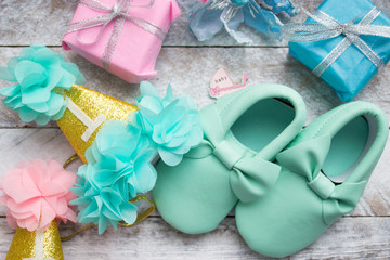 Little girlie baby shoes on a wood