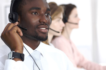 African american call operator in headset. Call center business or customer service concept