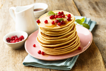 Homemade pancakes with berries and maple syrup