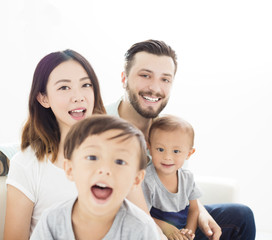 close up mixed race family in living room.